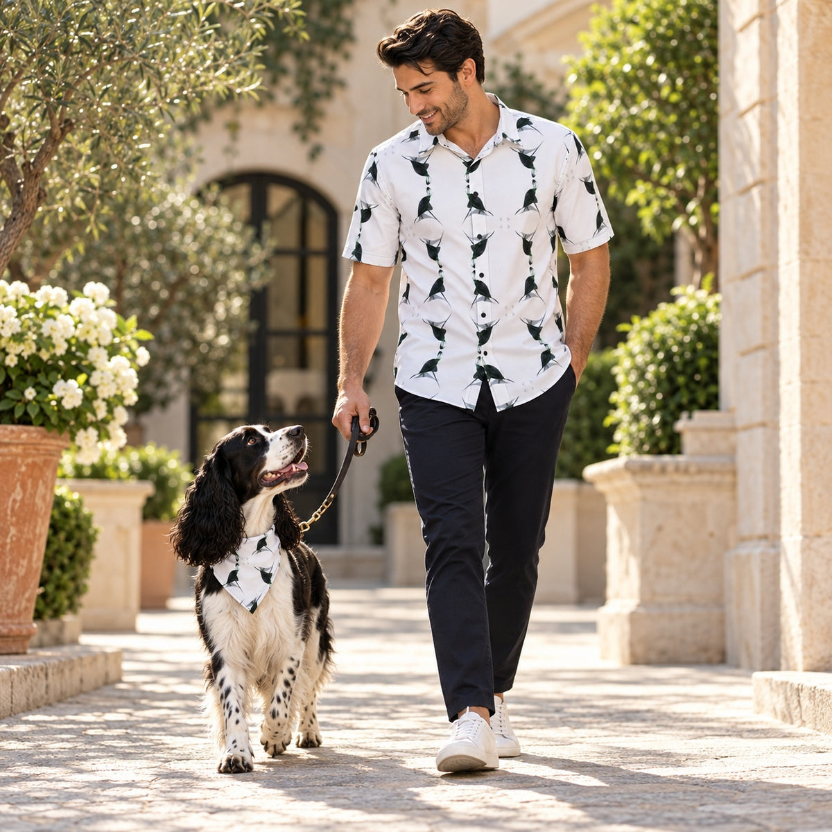 Man wearing Jezebel's Tongue ArtDogs men's short sleeve shirt walking with a black-and-white English Springer Spaniel in a matching bandana
