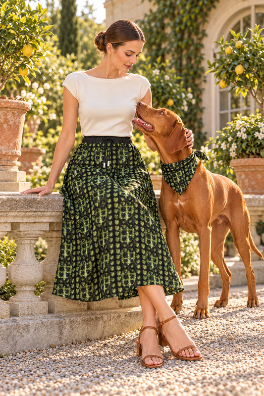 Leaves Calf-length or below Midi Skirt — Front with Vizsla companion, seated owner. Dark olive/black dense small vertical Leaves artwork, black elastic drawstring waist and calf-length hem. Available Real100%Silk Satin85gsm.