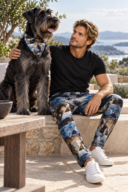 Spirit of Jezebel Mens Tracksuit Trousers — adult model with adult salt-and-pepper Giant Schnauzer, sitting alert beside its owner in matching artwork.