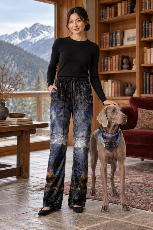 Into the Light Women’s Trousers — front with registered weimaraner dog companion. Charcoal, smoky gray, blue and muted amber original artwork.