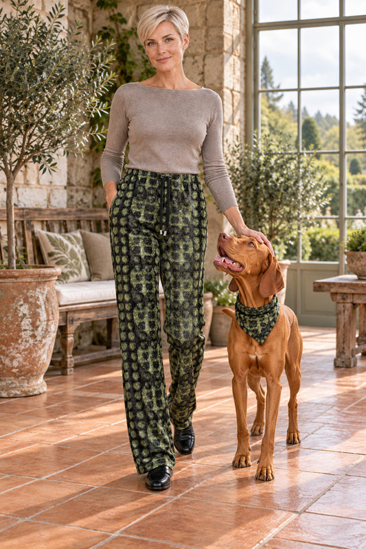 Leaves Women’s Trousers — front with registered vizsla dog companion. Olive-green and charcoal-black original Leaves artwork.